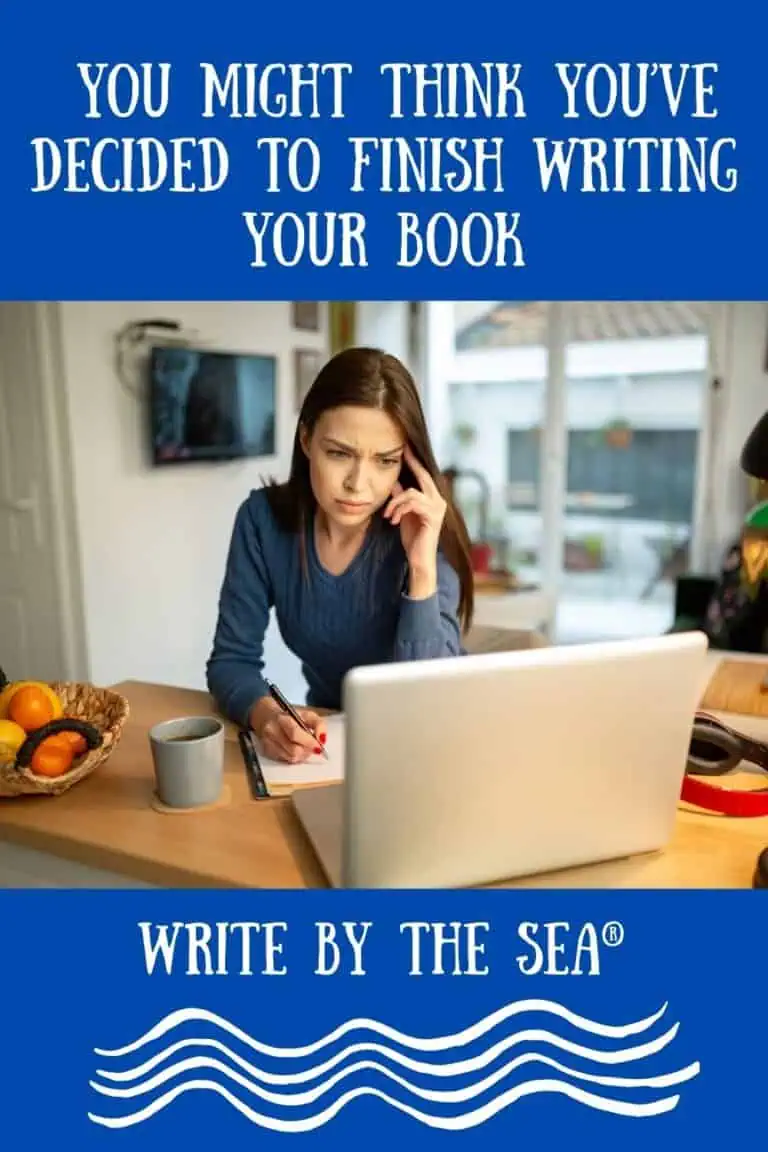 Woman contemplating finishing her book at a desk with laptop and notes.