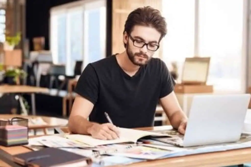 Man working on writing project inspired by Law of Attraction principles.